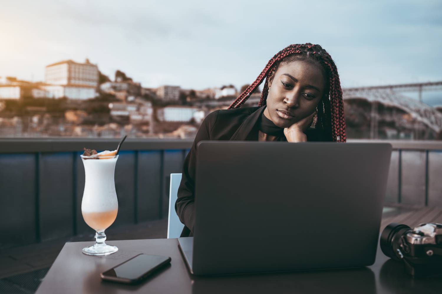African girl works remotely at a cafe