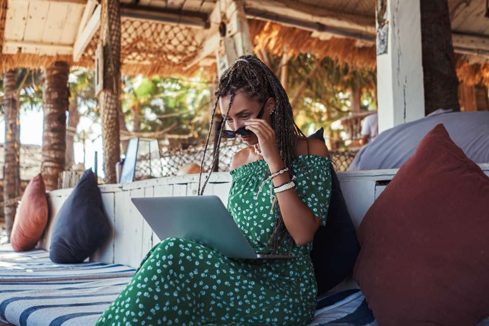 Business woman sitting on sofa with her modern laptop