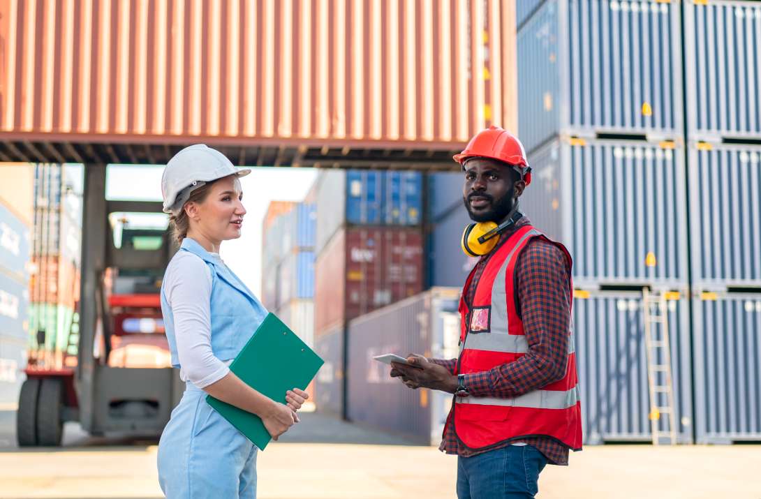 Foreman checking containers in the terminal, at import and export business logistic company.