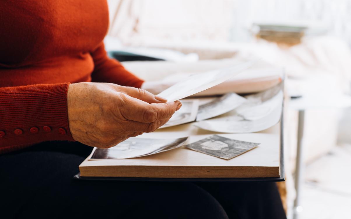Hand holding photos and documents