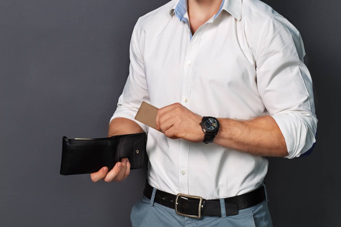 Man in short and pants taking out a card from his wallet