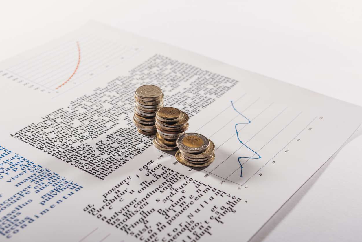 Selective focus of coins stacks on document with graph