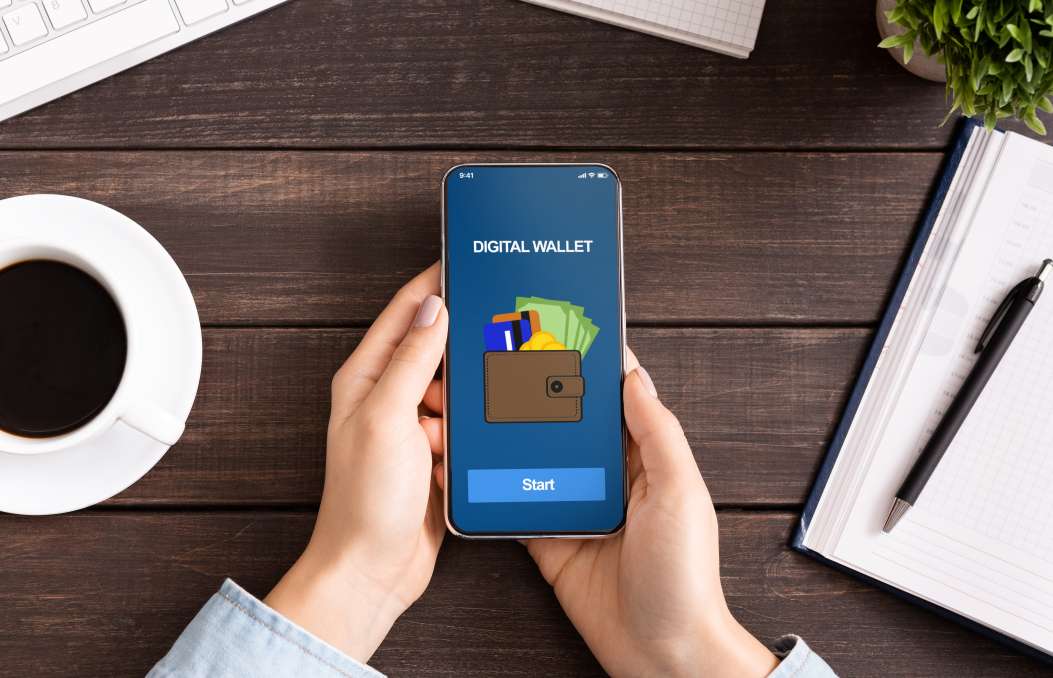 Woman holding smartphone with digital wallet application