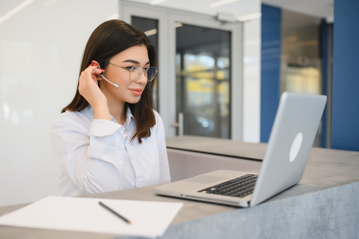 Young woman behind the reception desk