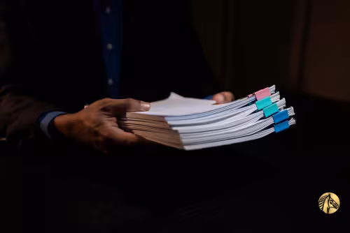 Hands holding a stack of legal financial documents from reliable proof of funds providers.